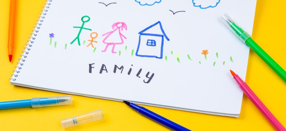 Home, love, family, still life concept. felt-tip pen lying on a paper with children's drawing family. Selective focus, copy space background